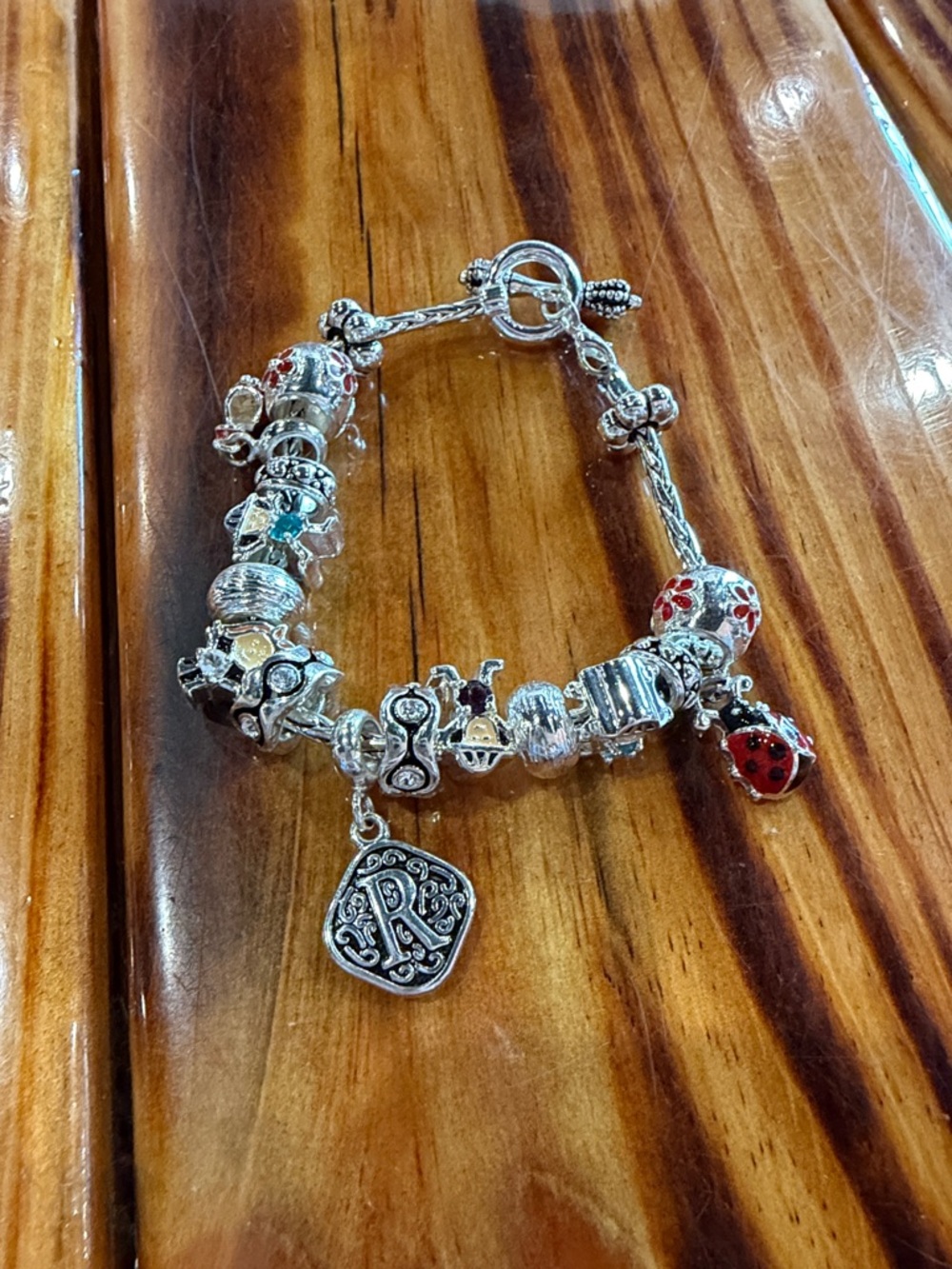 Silver Charm Bracelet with Red and Black Enamel Accents